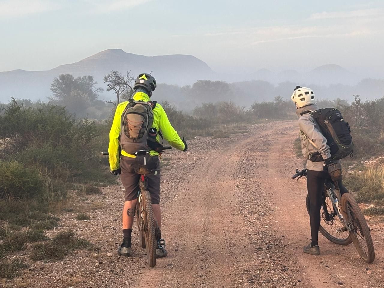 Two riders on a gravel road in the morning mist, Freedom Challenge 2026