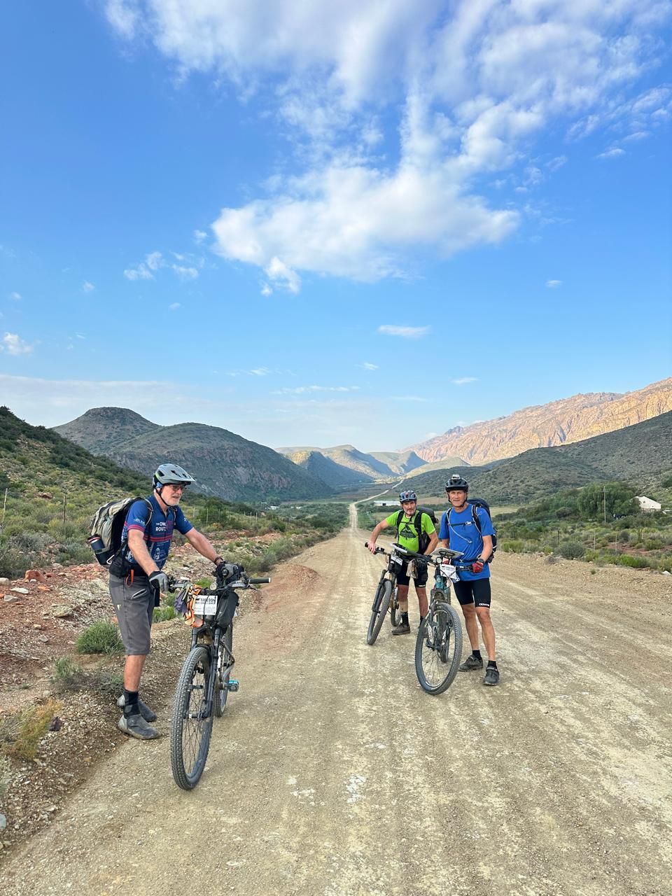 Riders regrouping on a gravel road between the mountains, Freedom Challenge 2026
